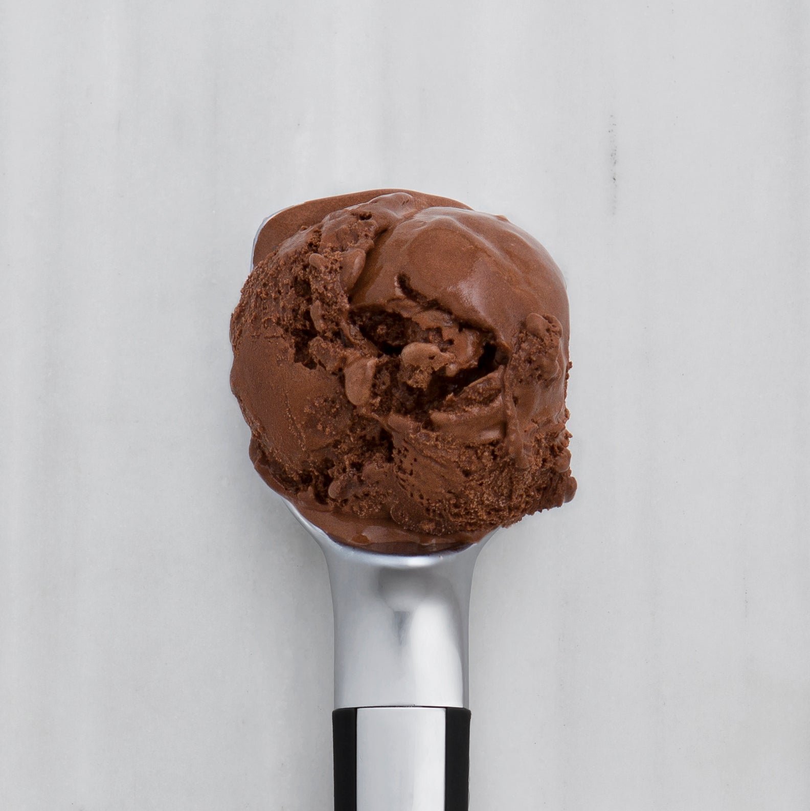 Triple Chocolate ice cream scoop on a white background